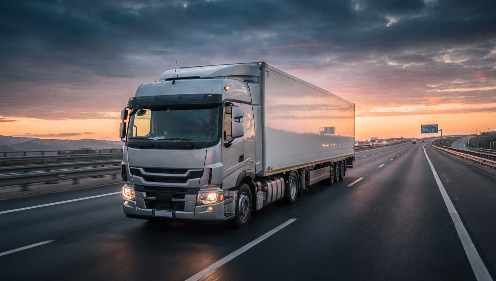 Truck driving on a European motorway at dusk